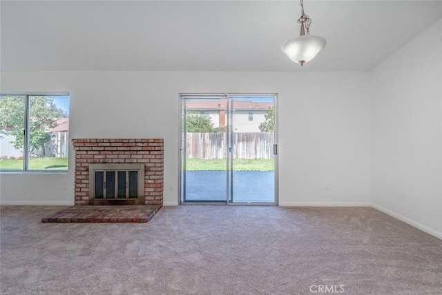 unfurnished living room featuring a fireplace and light colored carpet