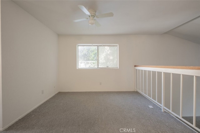 carpeted empty room featuring ceiling fan and lofted ceiling