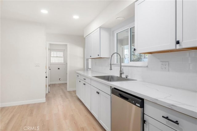 kitchen featuring light stone counters, dishwasher, light wood-type flooring, white cabinetry, and sink