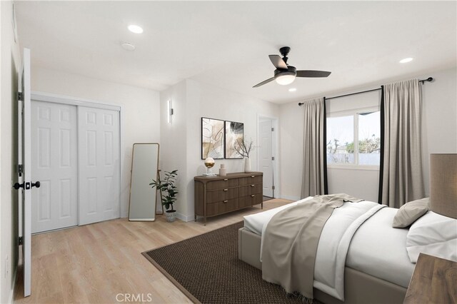 bedroom with a closet, ceiling fan, and light hardwood / wood-style floors