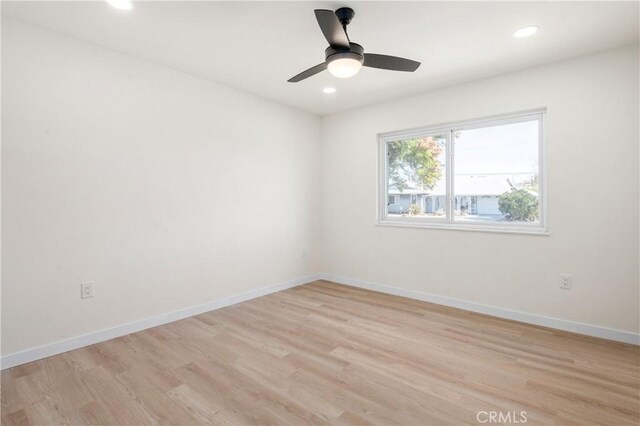 empty room with ceiling fan and light wood-type flooring