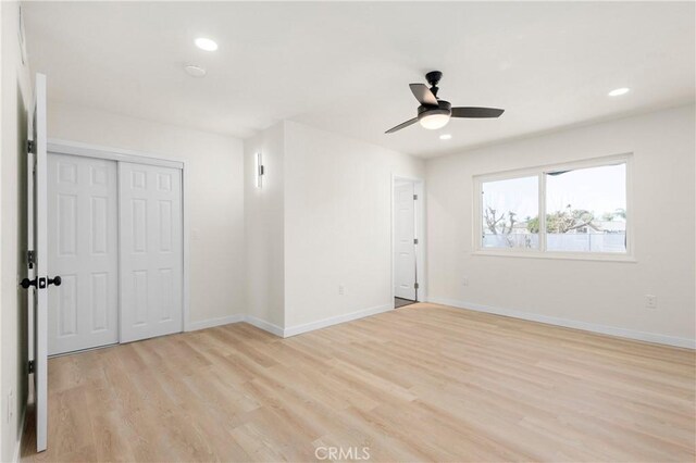 unfurnished room with ceiling fan and light hardwood / wood-style flooring