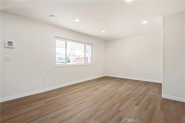 empty room with hardwood / wood-style floors