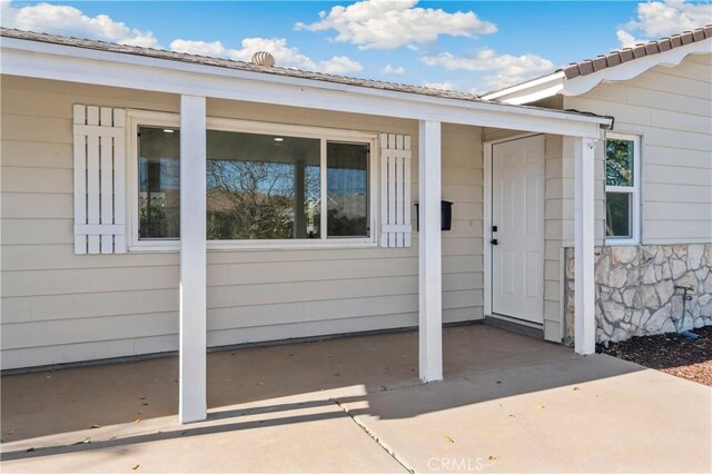 doorway to property with a patio