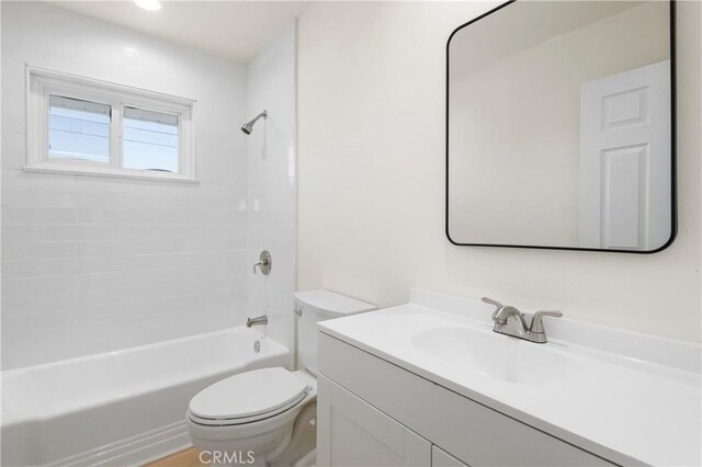 full bathroom featuring bathing tub / shower combination, vanity, and toilet