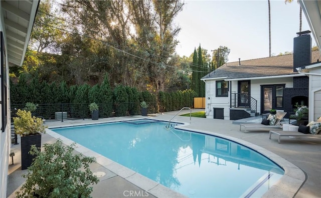 view of swimming pool featuring a patio area