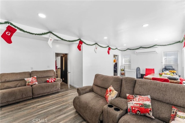 living room featuring a wall unit AC and hardwood / wood-style flooring