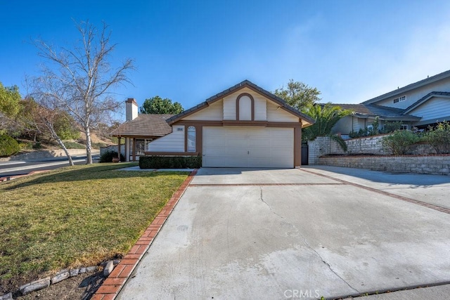 view of front of house with a garage and a front yard