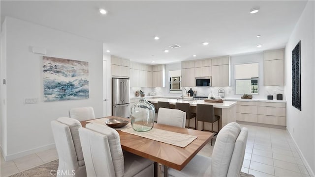 tiled dining space featuring sink