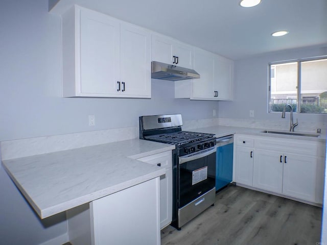 kitchen featuring sink, stainless steel appliances, light hardwood / wood-style floors, and white cabinets