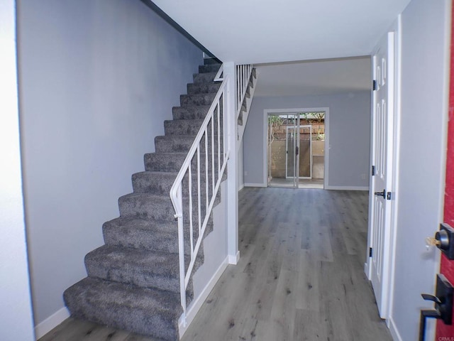 stairway with hardwood / wood-style flooring