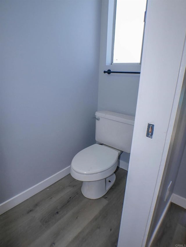 bathroom featuring toilet and wood-type flooring