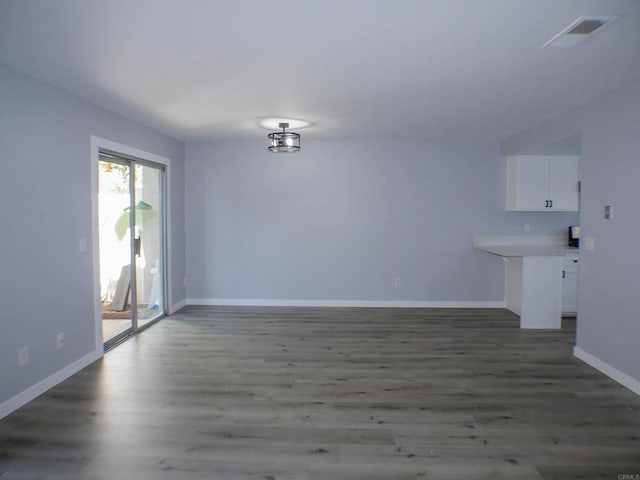 spare room with dark wood-type flooring