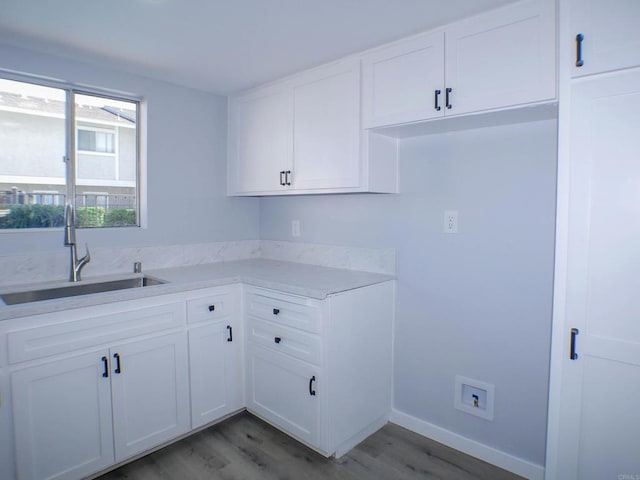 laundry room featuring sink and dark wood-type flooring