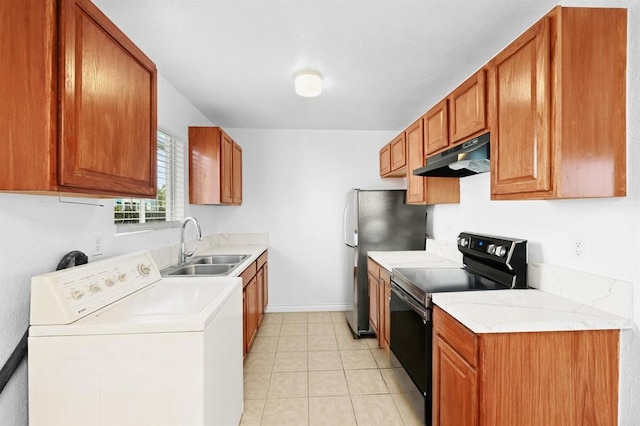 kitchen featuring light tile patterned floors, black electric range oven, stainless steel refrigerator, washer / clothes dryer, and sink