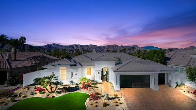 view of front of home featuring a garage and a mountain view