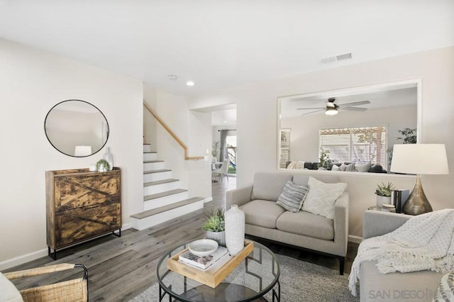 living room with hardwood / wood-style floors and ceiling fan