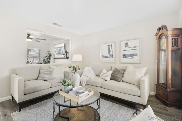 living room featuring dark hardwood / wood-style floors and ceiling fan