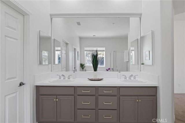 bathroom featuring walk in shower and vanity