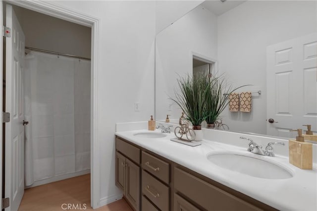 bathroom with vanity, hardwood / wood-style floors, and walk in shower