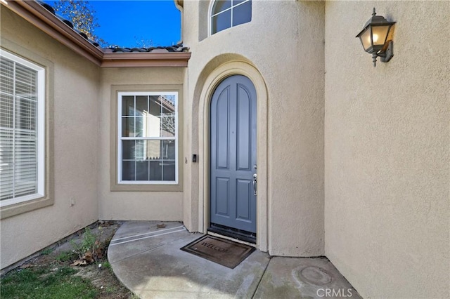 doorway to property with a patio