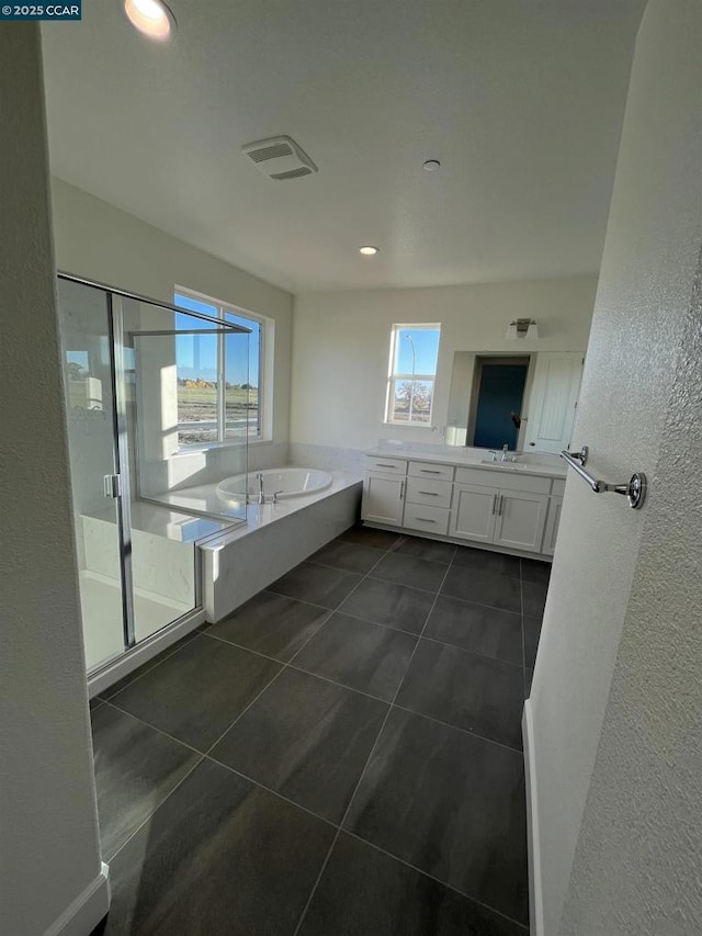 bathroom featuring tile patterned floors, independent shower and bath, and vanity