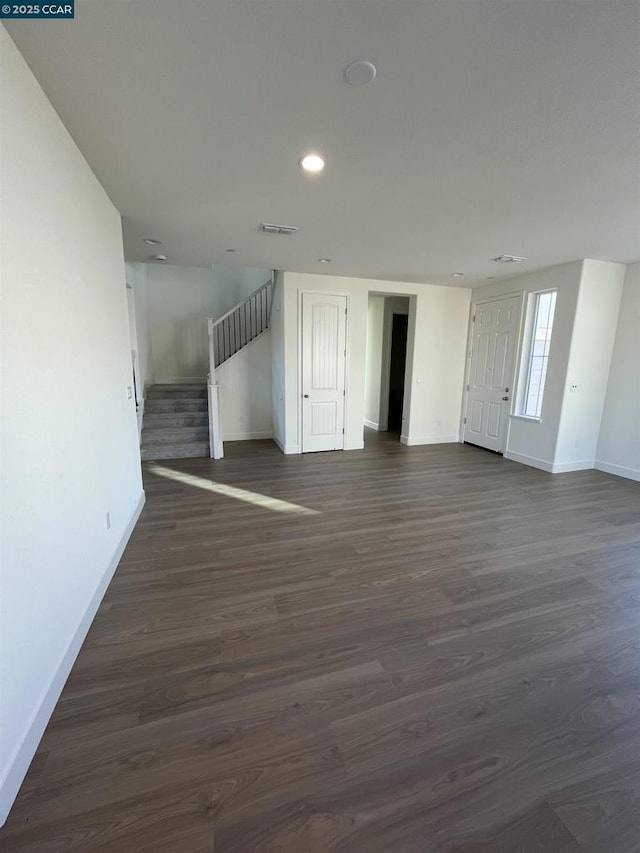 unfurnished living room featuring dark hardwood / wood-style flooring