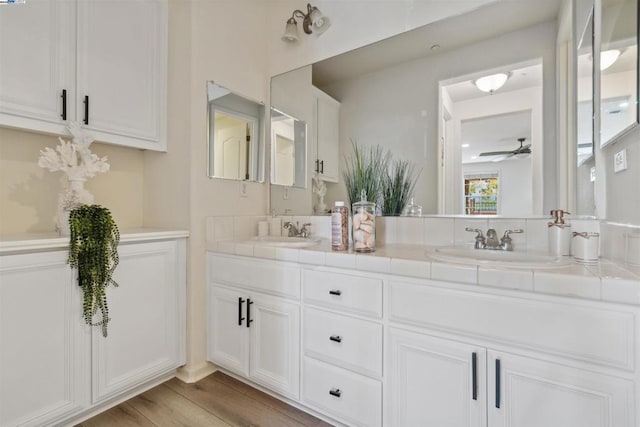 bathroom with ceiling fan, wood-type flooring, and vanity