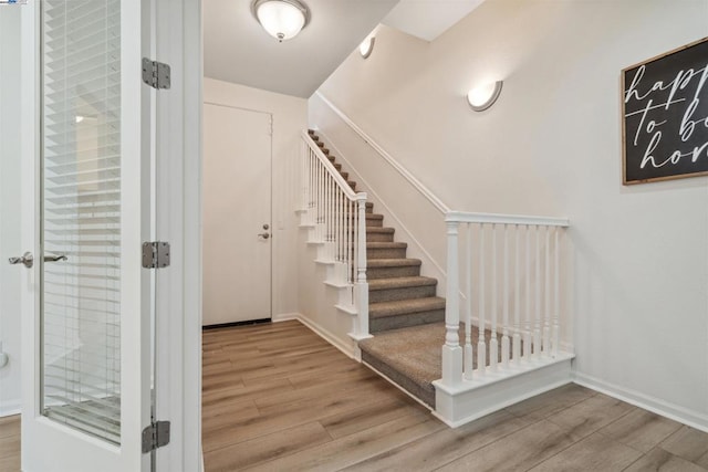 stairway featuring hardwood / wood-style flooring