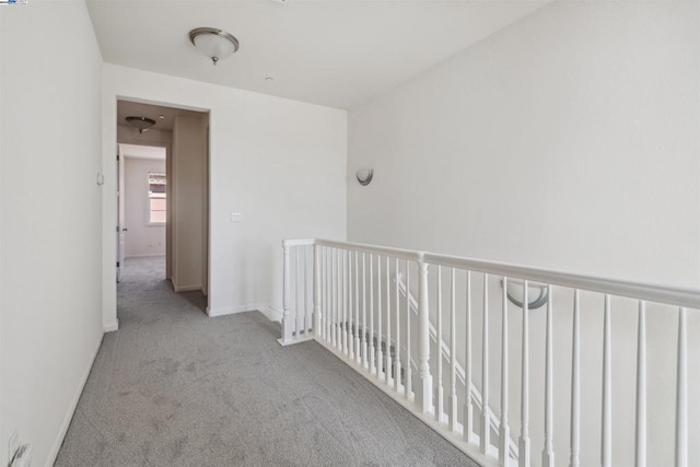 hallway with light colored carpet