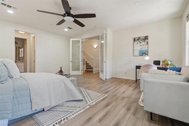 bedroom featuring ensuite bathroom, light wood-type flooring, and ceiling fan