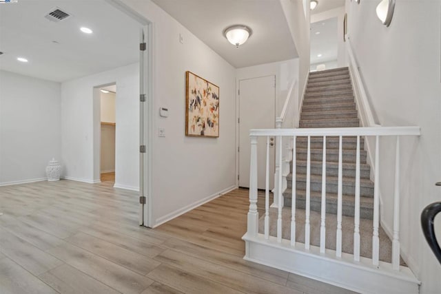 stairway with hardwood / wood-style flooring