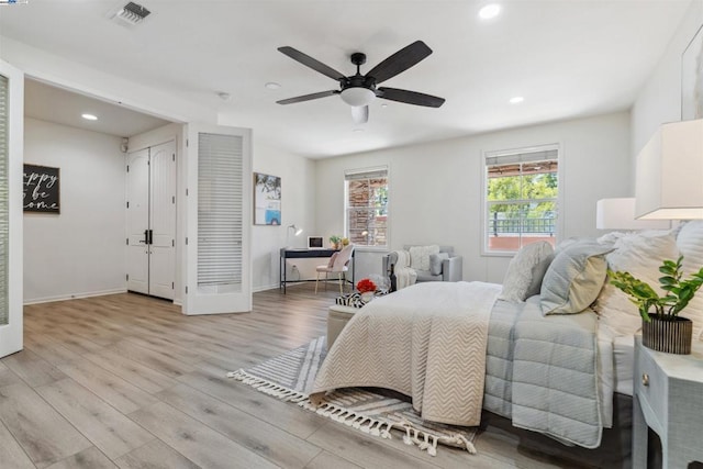 bedroom with ceiling fan and light wood-type flooring