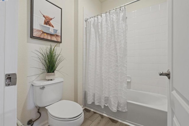 bathroom with toilet, shower / tub combo, and hardwood / wood-style floors