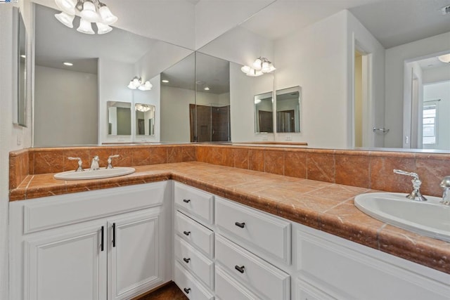 bathroom with a shower with door and vanity