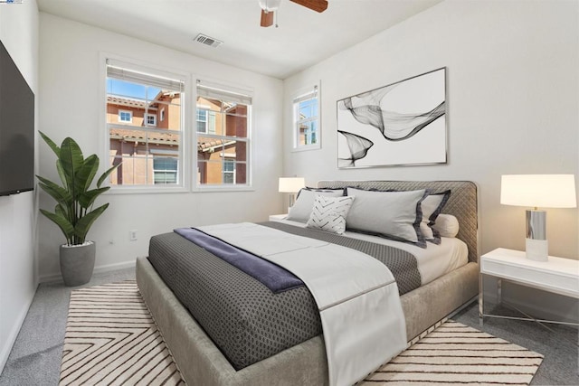 bedroom featuring ceiling fan and carpet