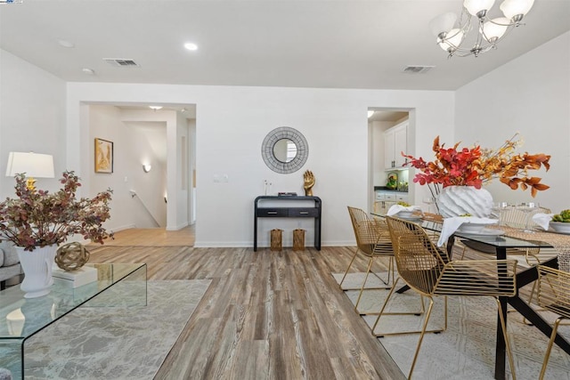 dining room featuring light hardwood / wood-style floors and a notable chandelier