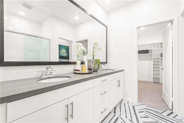 bathroom featuring vanity and a shower with shower door