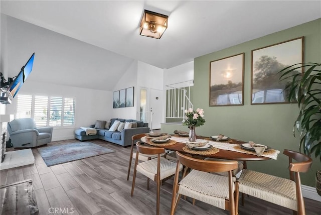 dining space featuring vaulted ceiling