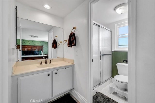 bathroom with vanity, toilet, walk in shower, and tile patterned flooring