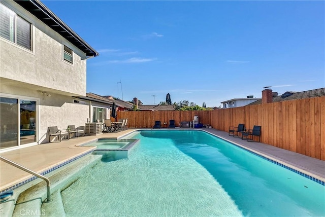 view of pool featuring an in ground hot tub and a patio area