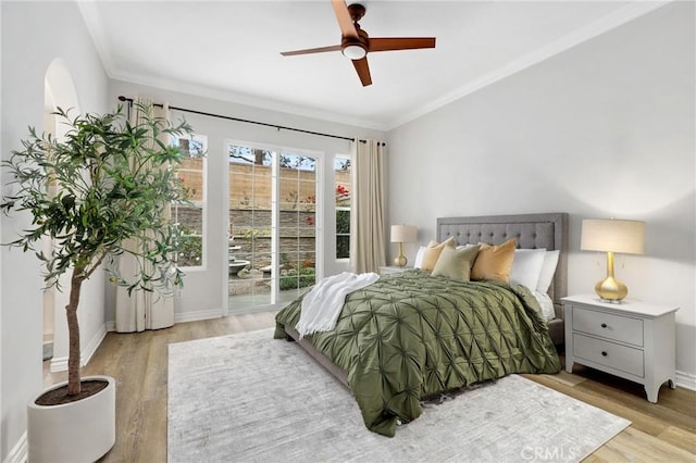 bedroom featuring ceiling fan, light wood-type flooring, and ornamental molding