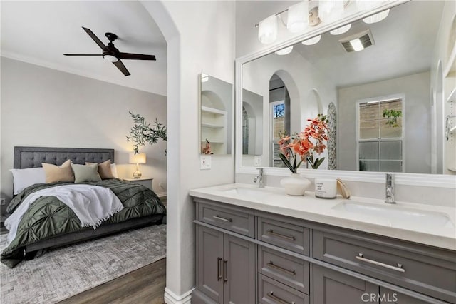 bathroom with ceiling fan, wood-type flooring, and vanity