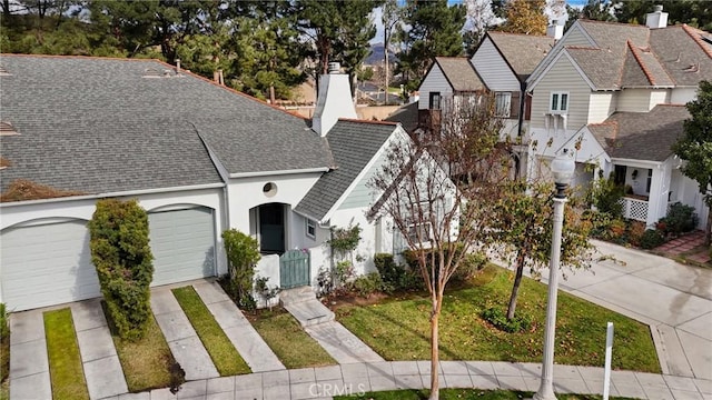 view of front of home featuring a garage and a front yard