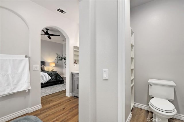 bathroom with toilet, ceiling fan, hardwood / wood-style flooring, and vanity