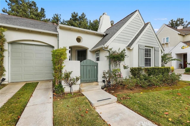 view of front of property with a front yard and a garage