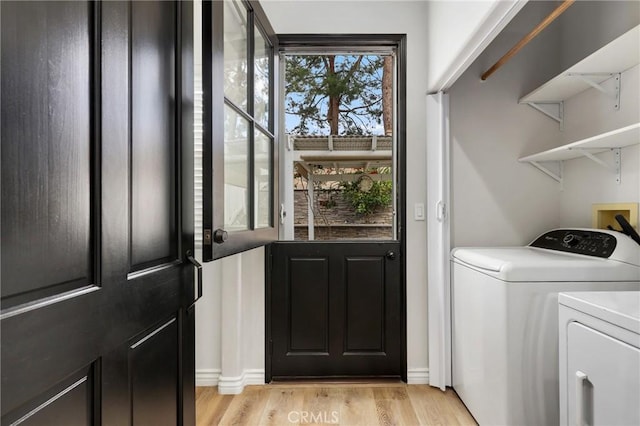 washroom featuring independent washer and dryer and light wood-type flooring