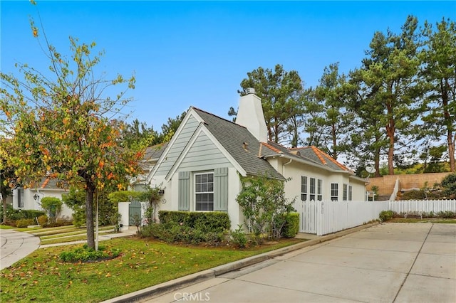 view of property exterior featuring a lawn