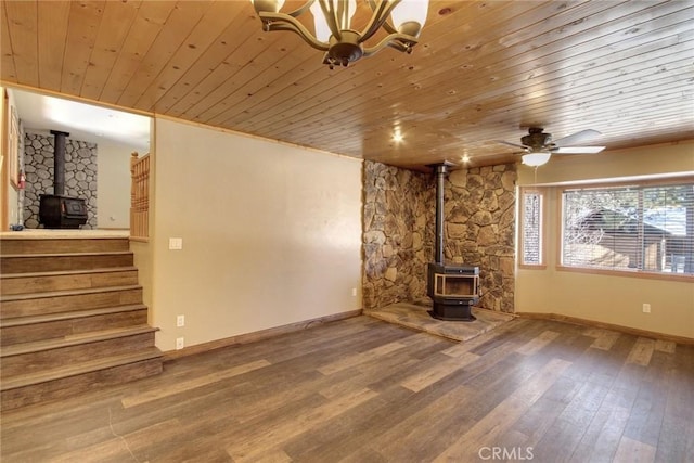 unfurnished living room featuring wooden ceiling, hardwood / wood-style flooring, and a wood stove