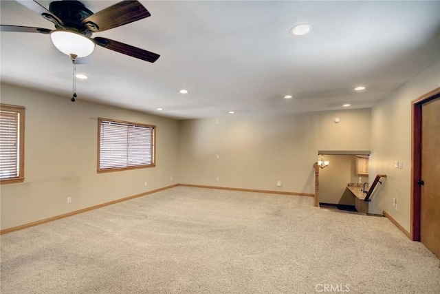 unfurnished room with ceiling fan and light colored carpet